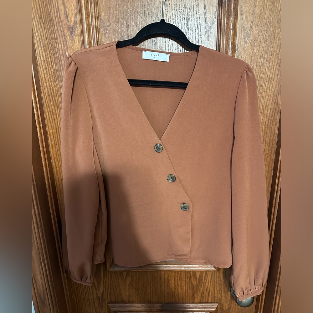 Brown Elodie blouse with puff sleeves, button details, and cinched wrist detail